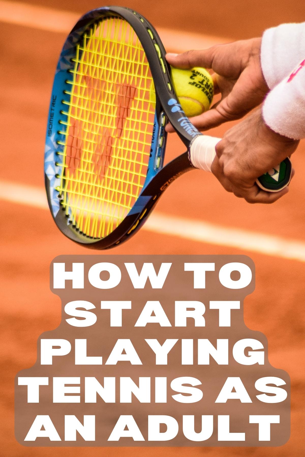 An image with a tennis player in red clay court, you only see the hands of the player getting ready to serve and his hands are holding a racket and a tennis ball.
